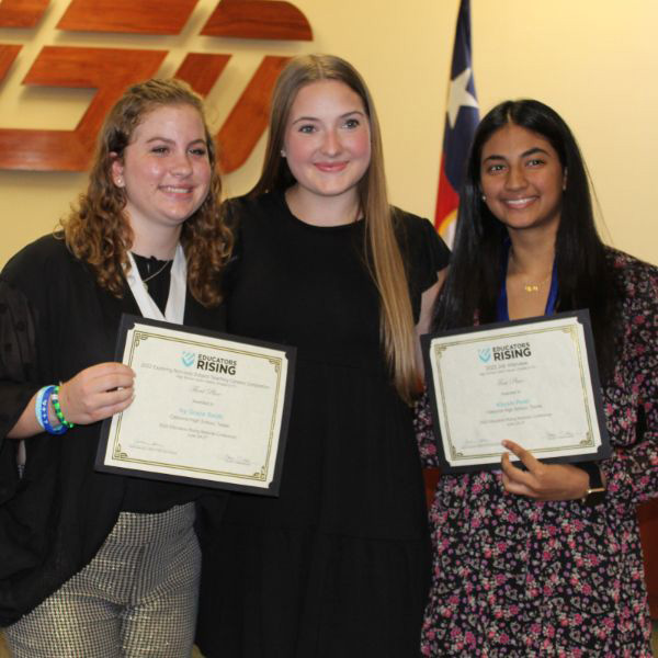  Three girls holding certificates